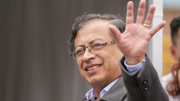 Gustavo Petro, presidential candidate with the Historical Pact coalition, waves upon his arrival to vote in a presidential runoff in Bogota, Colombia, Sunday, June 19, 2022. (AP Photo/Fernando Vergara)