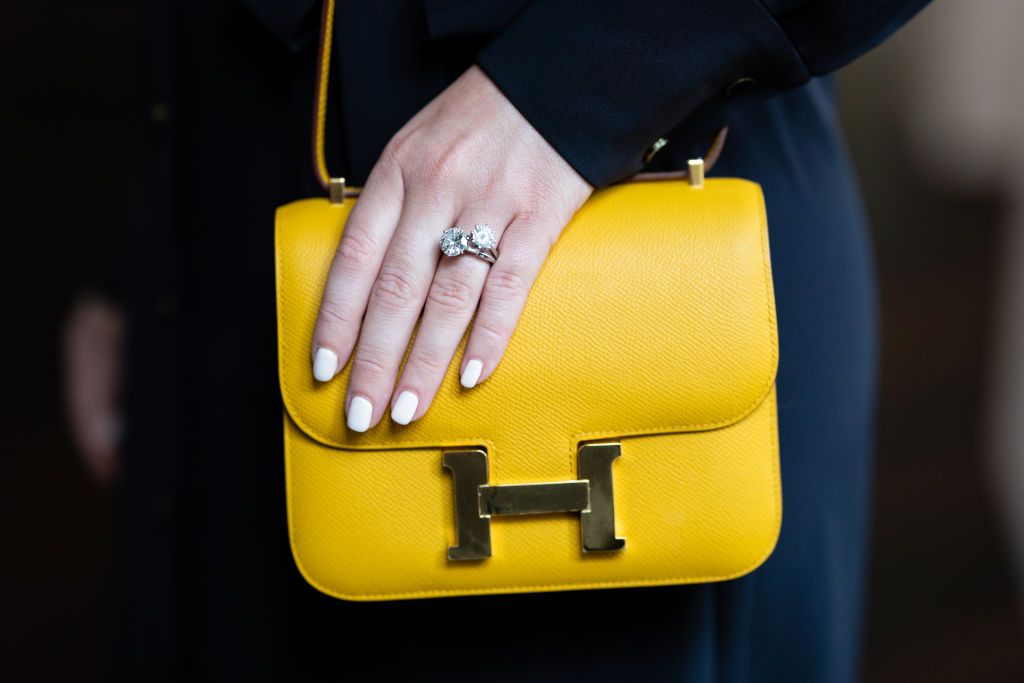 COLOGNE, GERMANY - SEPTEMBER 10: Hermes Jaune Epsom Mini Constance 18 Gold Hardware and Diamond rings are seen at Palais Oppenheim on September 10, 2021 in Cologne, Germany. The works are on view for the public until 16th September, ahead of the Sotheby's Contemporary Art & Luxury Sales. (Photo by Joshua Sammer/Getty Images for Sotheby's Germany)