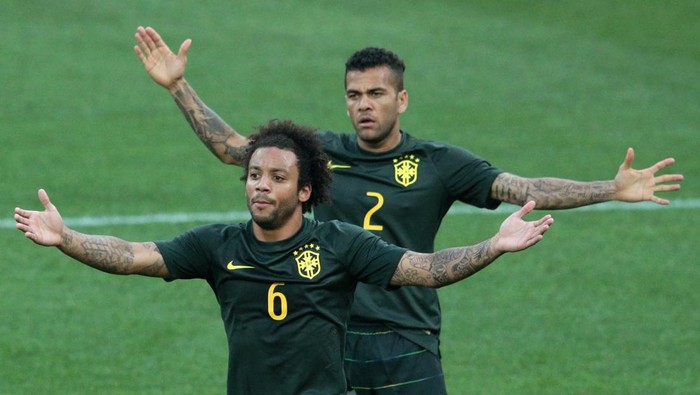 SAO PAULO, BRAZIL - JUNE 11: Marcelo (L) and Dani Alves of Brazil react during a Brazil training session ahead of the 2014 FIFA World Cup Brazil opening match against Croatia at Arena de Sao Paulo on June 11, 2014 in Sao Paulo, Brazil.  (Photo by Adam Pretty/Getty Images)