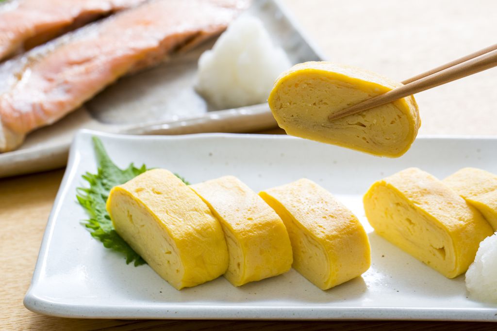 Traveler Asian blogger women travel in Bangkok, Thailand, beautiful female using Women travel in Thailand concept.Woman enjoy her bowl of noodles in outdoor night market in Bangkok city