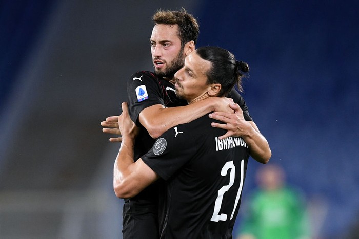 Hakan Calhanoglu of AC Milan celebrates with Zlatan Ibrahimovic of AC Milan scoring first goal during the Serie A match between SS Lazio and AC Milan at Stadio Olimpico, Rome, Italy on 4 July 2020. (Photo by Giuseppe Maffia/NurPhoto via Getty Images)