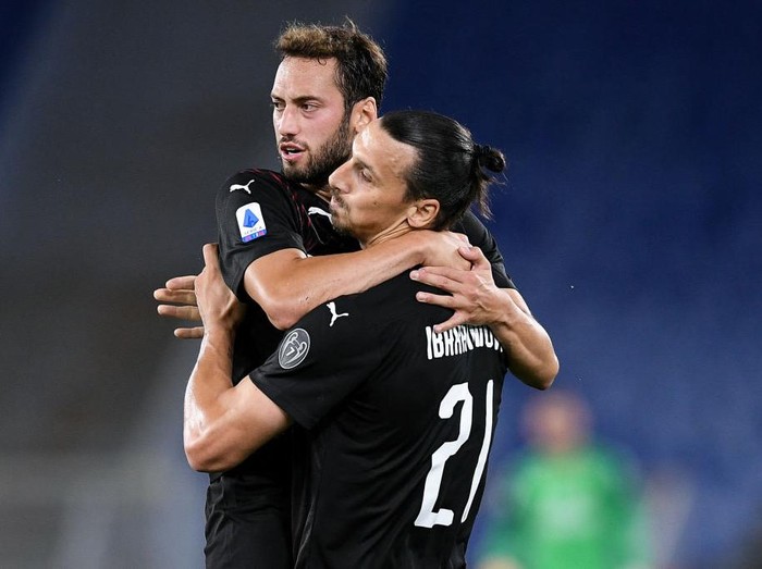 Hakan Calhanoglu of AC Milan celebrates with Zlatan Ibrahimovic of AC Milan scoring first goal during the Serie A match between SS Lazio and AC Milan at Stadio Olimpico, Rome, Italy on 4 July 2020. (Photo by Giuseppe Maffia/NurPhoto via Getty Images)