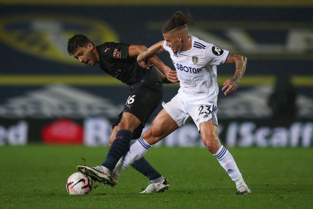 LEEDS, ENGLAND - OCTOBER 03: Rodri of Manchester City and Kalvin Phillips of Leeds United during the Premier League match between Leeds United and Manchester City at Elland Road on October 3, 2020 in Leeds, United Kingdom. Sporting stadiums around the UK remain under strict restrictions due to the Coronavirus Pandemic as Government social distancing laws prohibit fans inside venues resulting in games being played behind closed doors. (Photo by Robbie Jay Barratt - AMA/Getty Images)
