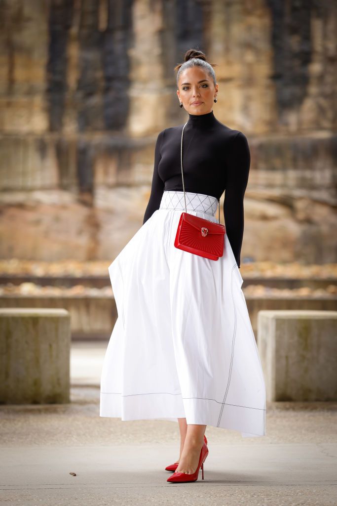 SYDNEY, AUSTRALIA - MAY 09:  Olympia Valance wearing Tory Burch top and white skirt, Bulgari bag and Kurt Gaia shoes at Afterpay Australian Fashion Week 2022 on May 09, 2022 in Sydney, Australia. (Photo by Hanna Lassen/Getty Images)