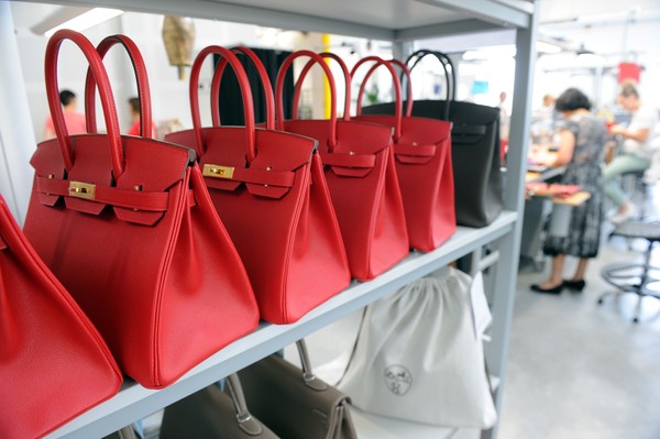 TO GO WITH AFP STORY BY REGINE LAMOTHE
A photo taken on June 11, 2015 shows Hermes Birkin bags at the Maroquinerie de la Tardoire, a Hermes workshop specialized in products made with calfskin, in Montbron, southwestern France. AFP PHOTO / MEHDI FEDOUACH (Photo by Mehdi FEDOUACH / AFP) (Photo by MEHDI FEDOUACH/AFP via Getty Images)