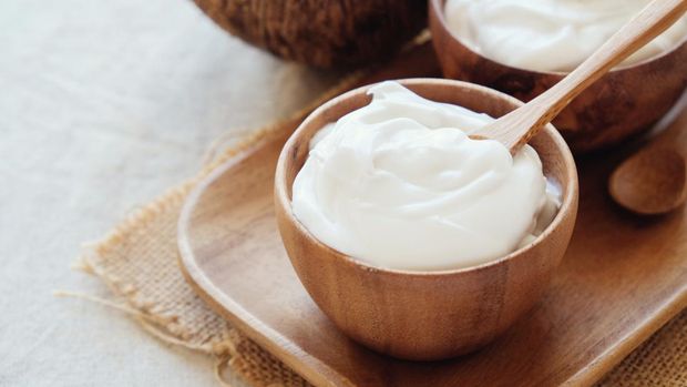 homemade organic coconut greek yogurt in wooden bowl