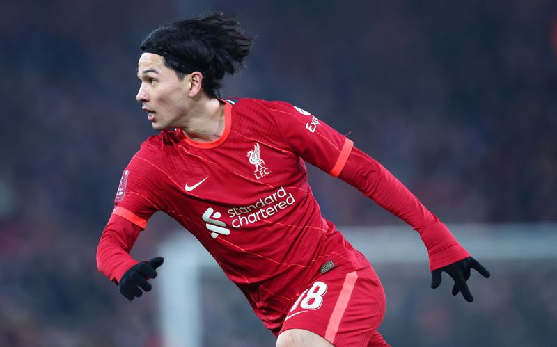 LONDON, ENGLAND - MAY 14: Liverpool's Takumi Minamino celebrates winning the FA Cup after a penalty shoot-out during The FA Cup Final match between Chelsea and Liverpool at Wembley Stadium on May 14, 2022 in London, England. (Photo by Andrew Kearns - CameraSport via Getty Images)