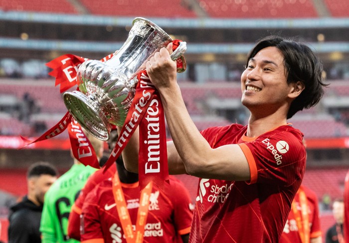 LONDON, ENGLAND - MAY 14: Liverpools Takumi Minamino celebrates winning the FA Cup after a penalty shoot-out during The FA Cup Final match between Chelsea and Liverpool at Wembley Stadium on May 14, 2022 in London, England. (Photo by Andrew Kearns - CameraSport via Getty Images)