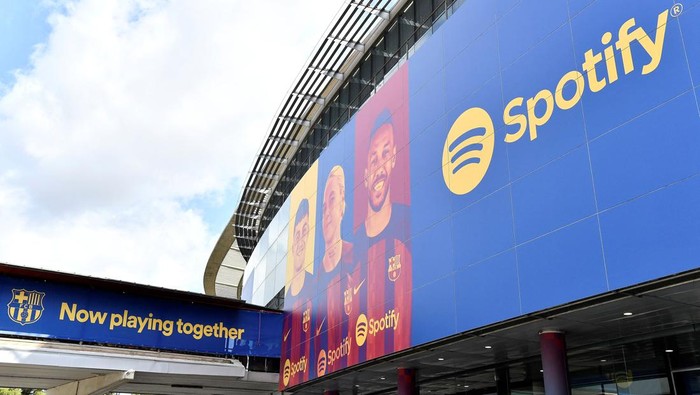 This photograph taken on July 1, 2022 shows the logo of Spotify Technology S.A on the banner at the entrance of the Camp Nou stadium in Barcelona. (Photo by Pau BARRENA / AFP) (Photo by PAU BARRENA/AFP via Getty Images)