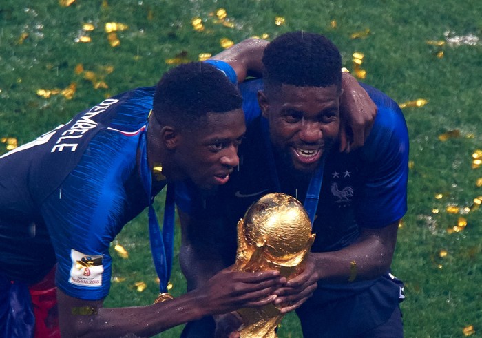 Samuel Umtiti MOSCOW, RUSSIA - JULY 15: Ousmane Dembele (L) and Samuel Umtiti of France celebrates with the trophy after the 2018 FIFA World Cup Russia Final between France and Croatia at Luzhniki Stadium on July 15, 2018 in Moscow, Russia. (Photo by Quality Sport Images/Getty Images)