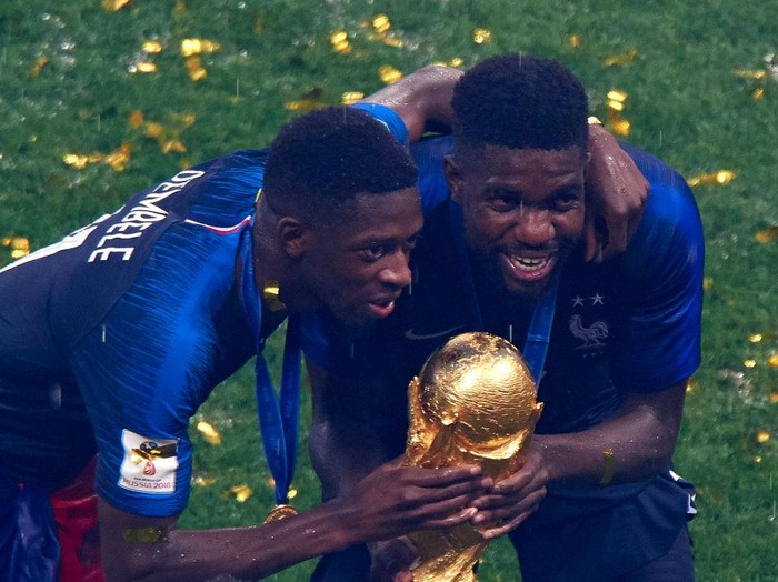 MOSCOW, RUSSIA - JULY 15:  Ousmane Dembele (L) and Samuel Umtiti of France celebrates with the trophy after the 2018 FIFA World Cup Russia Final between France and Croatia at Luzhniki Stadium on July 15, 2018 in Moscow, Russia.  (Photo by Quality Sport Images/Getty Images)