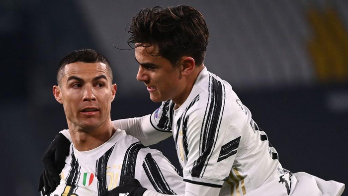 Juventus Portuguese forward Cristiano Ronaldo celebrates with Juventus Argentine forward Paulo Dybala (R) after opening the scoring during the Italian Serie A football match Juventus vs Udinese on January 3, 2021 at the Juventus stadium in Turin. (Photo by Marco BERTORELLO / AFP) (Photo by MARCO BERTORELLO/AFP via Getty Images)