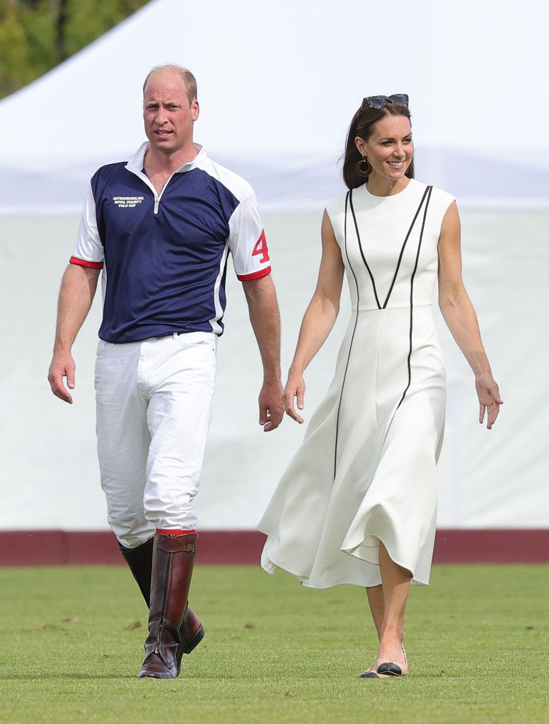 WINDSOR, ENGLAND - JULY 06: Prince William, Duke of Cambridge and Catherine, Duchess of Cambridge cross the pitch after the Royal Charity Polo Cup 2022 at Guards Polo Club  during the Outsourcing Inc. Royal Polo Cup at Guards Polo Club, Flemish Farm on July 06, 2022 in Windsor, England. (Photo by Chris Jackson/Getty Images for TLA Worldwide)