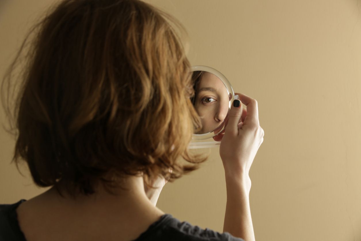 Mirror reflection of a woman's face, studio shot