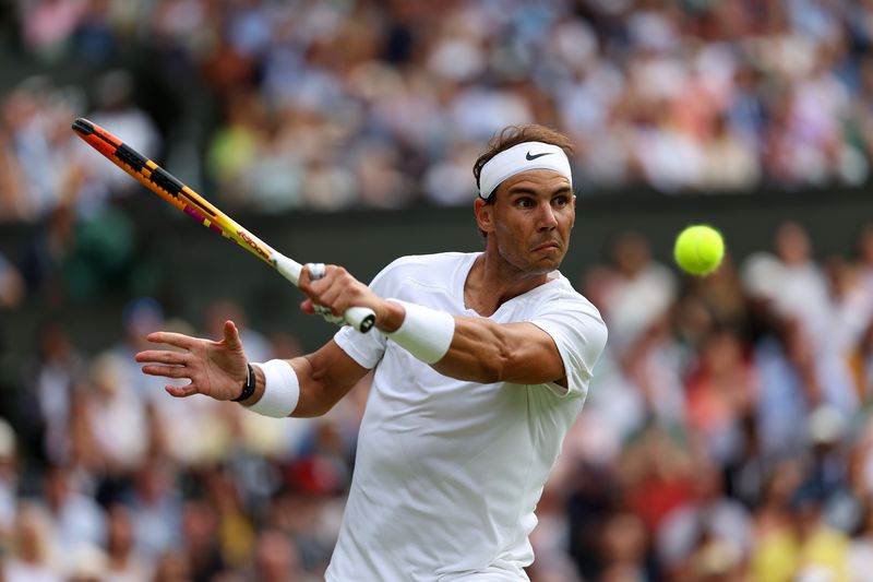 LONDON, ENGLAND - JULY 06: Rafael Nadal of Spain plays a backhand against Taylor Fritz of The United States during their Men's Singles Quarter Final match on day ten of The Championships Wimbledon 2022 at All England Lawn Tennis and Croquet Club on July 06, 2022 in London, England. (Photo by Clive Brunskill/Getty Images)