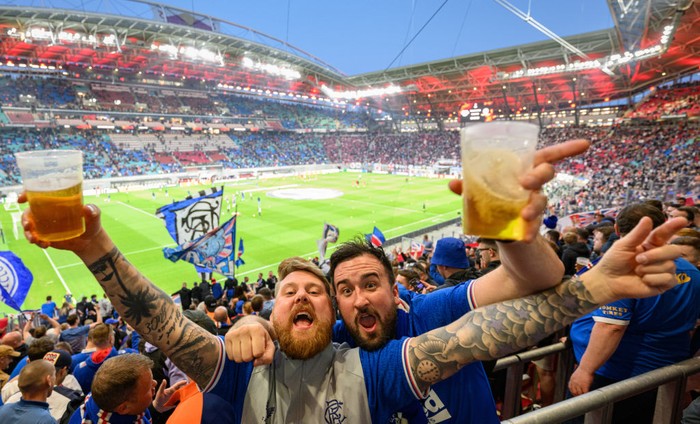 28 April 2022, Saxony, Leipzig: Soccer: Europa League, RB Leipzig - Glasgow Rangers, knockout round, semifinals, first leg, Red Bull Arena. Scottish fans of Glasgow celebrate in the stadium before the match. Photo: Robert Michael/dpa (Photo by Robert Michael/picture alliance via Getty Images)
