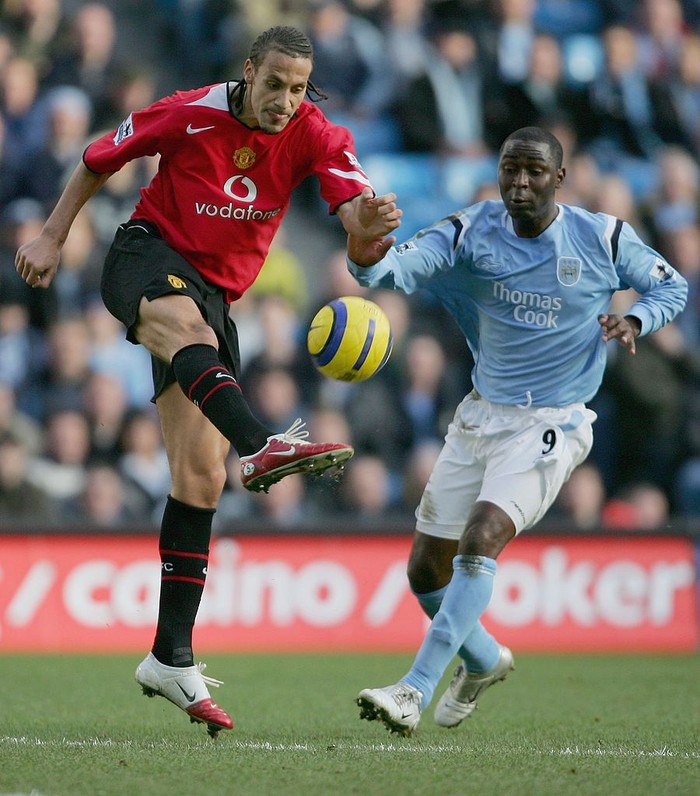 Andy Cole MANCHESTER, UNITED KINGDOM - JANUARY 14: Rio Ferdinand of Manchester United clears the ball from Andy Cole of Manchester City during the Barclays Premiership match between Manchester City and Manchester United at the City of Manchester Stadium on January 14, 2006 in Manchester, England. (Photo by Alex Livesey/Getty Images)