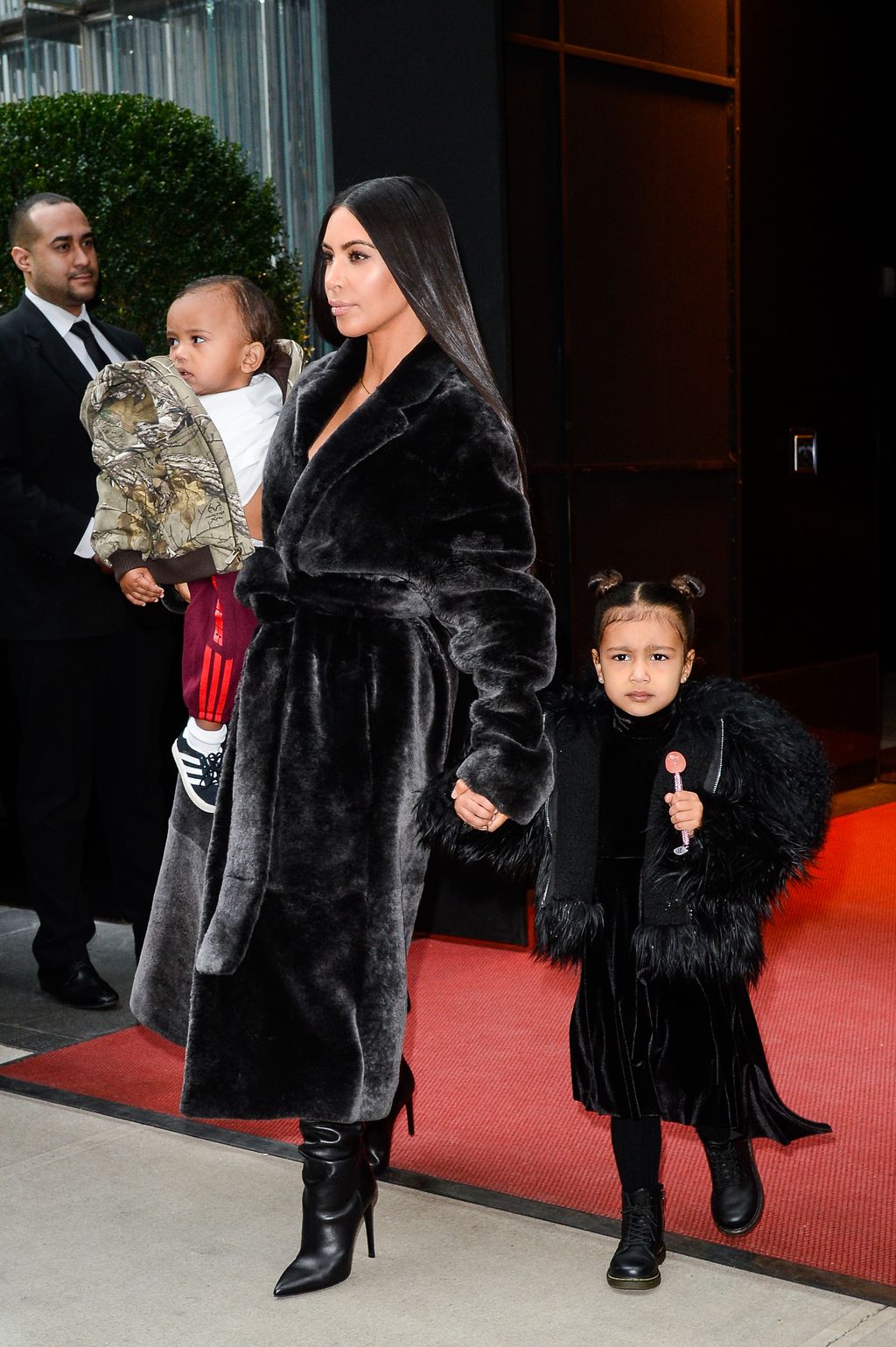 NEW YORK, NY - FEBRUARY 01:  (L to R) Saint West, television personality Kim Kardashian West, and North West leave their Midtown Manhattan hotel on February 01, 2017 in New York City.  (Photo by Ray Tamarra/GC Images)