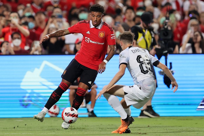 BANGKOK, THAILAND - JULY 12: Jadon Sancho #25 of Manchester United controls the ball against Luke Chambers #88 of Liverpool during the first half of a preseason friendly match at Rajamangala National Stadium on July 12, 2022 in Bangkok, Thailand. (Photo by Pakawich Damrongkiattisak/Getty Images)