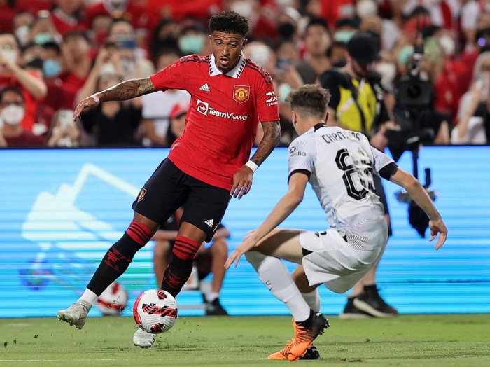 BANGKOK, THAILAND - JULY 12: Jadon Sancho #25 of Manchester United controls the ball against Luke Chambers #88 of Liverpool during the first half of a preseason friendly match at Rajamangala National Stadium on July 12, 2022 in Bangkok, Thailand. (Photo by Pakawich Damrongkiattisak/Getty Images)