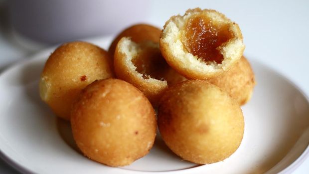 Indonesian Traditional Fritters, Misro, on white background.  Made from deep fried cassava and filled with palm sugar.