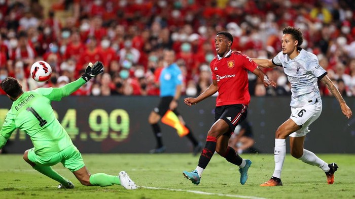 BANGKOK, THAILAND - JULY 12: Anthony Martial #9 of Manchester United scores his teams third goal against goalkeeper Alisson Becker #1 and Rhys Williams #46 of Liverpool during the first half of a preseason friendly match at Rajamangala National Stadium on July 12, 2022 in Bangkok, Thailand. (Photo by Pakawich Damrongkiattisak/Getty Images)