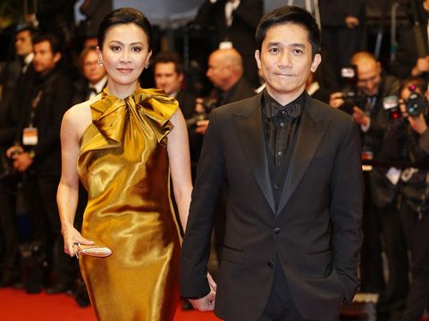 Chinese actor Tony Leung (R) and his wife Chinese actress Carina Lau arrive on May 17, 2013 for the screening of the film 