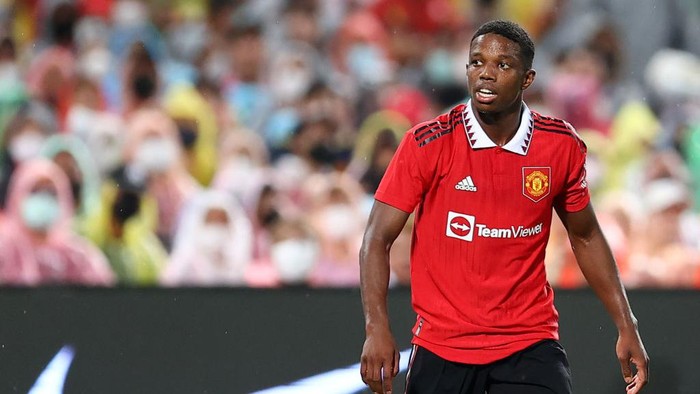 BANGKOK, THAILAND - JULY 12: Tyrell Malacia #12 of Manchester United looks on during the second half of a preseason friendly match against Liverpool at Rajamangala National Stadium on July 12, 2022 in Bangkok, Thailand. (Photo by Pakawich Damrongkiattisak/Getty Images)
