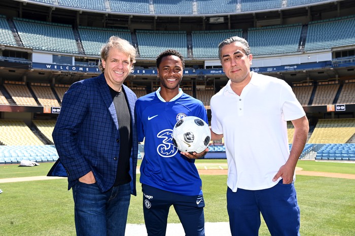 Raheem Sterling LOS ANGELES, CA - JULY 13: New Signing Raheem Sterling of Chelsea with Chelsea Co Owners Todd Boehly and Behdad Eghbali during a visit to Dodger Stadium on July 13, 2022 in Los Angeles, California. (Photo by Darren Walsh/Chelsea FC via Getty Images)