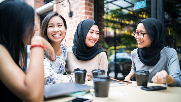 Young Malaysian girls talking to each other and enjoy the gathering.