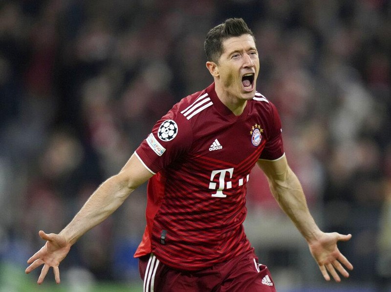 FILE - Bayern's Robert Lewandowski celebrates after scoring his side's opening goal during the Champions League, second leg, quarterfinal soccer match between Bayern Munich and Villareal at the Allianz Arena, in Munich, Germany, Tuesday, April 12, 2022. Barcelona is set to sign Poland striker Robert Lewandowski from Bayern Munich after the clubs reached an agreement in principle for his transfer, a person with knowledge of the negotiations tells The Associated Press. (AP Photo/Matthias Schrader, File)