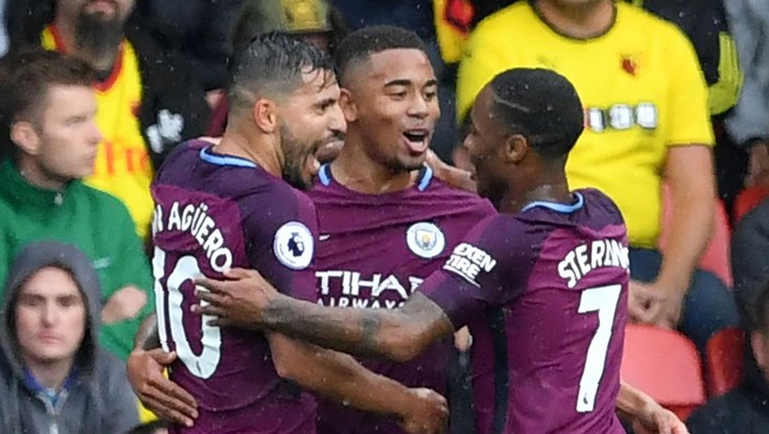 Manchester Citys Brazilian striker Gabriel Jesus (C) celebrates, with Manchester Citys Argentinian striker Sergio Aguero (L) and Manchester Citys English midfielder Raheem Sterling, scoring the teams third goal during the English Premier League football match between Watford and Manchester City at Vicarage Road Stadium in Watford, north of London on September 16, 2017. / AFP PHOTO / Ben STANSALL / RESTRICTED TO EDITORIAL USE. No use with unauthorized audio, video, data, fixture lists, club/league logos or live services. Online in-match use limited to 75 images, no video emulation. No use in betting, games or single club/league/player publications.  /         (Photo credit should read BEN STANSALL/AFP via Getty Images)