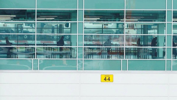 Passengers are seen social distancing as they queue to board a plane at Luton Airport, following the outbreak of the coronavirus disease (COVID-19), Luton, Britain, May 1, 2020. REUTERS/Andrew Boyers