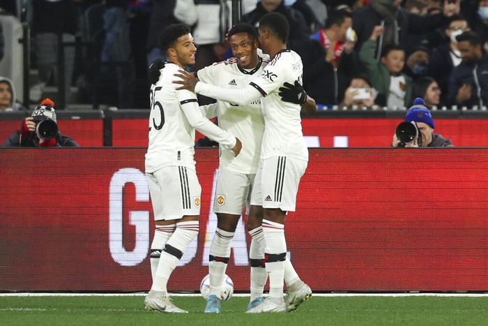 Manchester Uniteds Anthony Martial, centre, is congratulated by teammates Marcus Rashford, right, and Jadon Sancho, left, after scoring his teams first goal during a pre-season game between Manchester United and Crystal Palace at the Melbourne Cricket Ground in Melbourne, Australia, Tuesday, July 19, 2022. (AP Photo/Asanka Brendon Ratnayake)