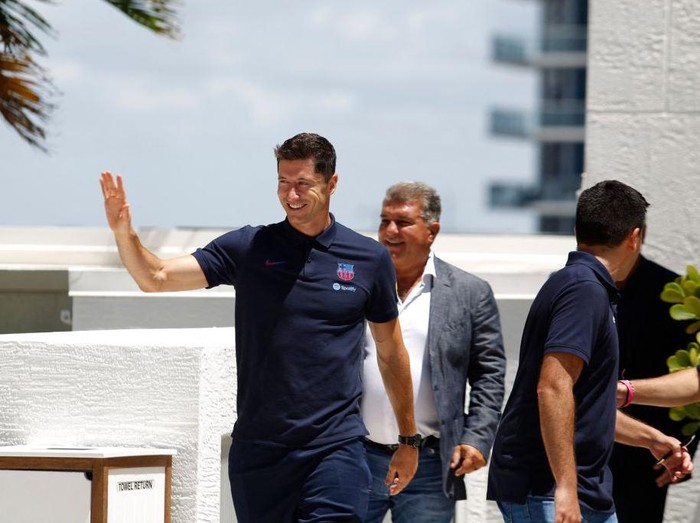 Polish football player Robert Lewandowski, with  Barcelona President Joan Laporta, arrives for a press conference in Fort Lauderdale, Florida, on July 20, 2022, as he is introduced as  club Barcelona newest player. - Lewandowski will bring the 'winning mentality' Barcelona need according to new teammate Andreas Christensen. The Polish superstar has arrived in Miami to complete his move to the La Liga giants from Bayern Munich ahead of a July 20, friendly with David Beckham's Inter Miami. (Photo by Marco BELLO / AFP) (Photo by MARCO BELLO/AFP via Getty Images)