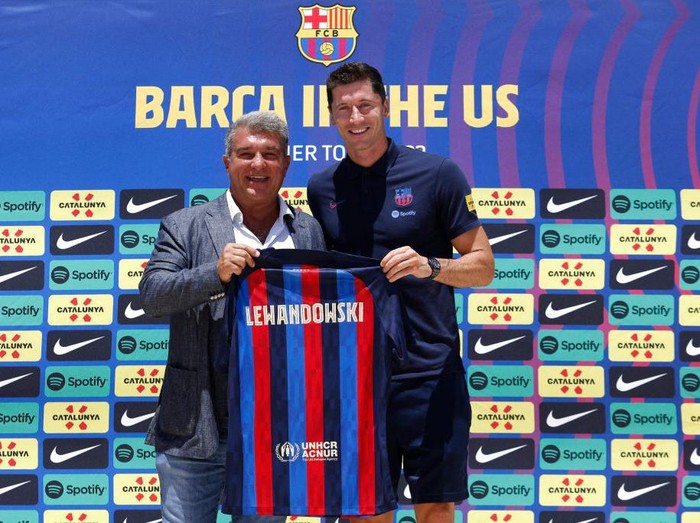 Polish football player Robert Lewandowski, with  Barcelona President Joan Laporta, arrives for a press conference in Fort Lauderdale, Florida, on July 20, 2022, as he is introduced as  club Barcelona newest player. - Lewandowski will bring the 'winning mentality' Barcelona need according to new teammate Andreas Christensen. The Polish superstar has arrived in Miami to complete his move to the La Liga giants from Bayern Munich ahead of a July 20, friendly with David Beckham's Inter Miami. (Photo by Marco BELLO / AFP) (Photo by MARCO BELLO/AFP via Getty Images)