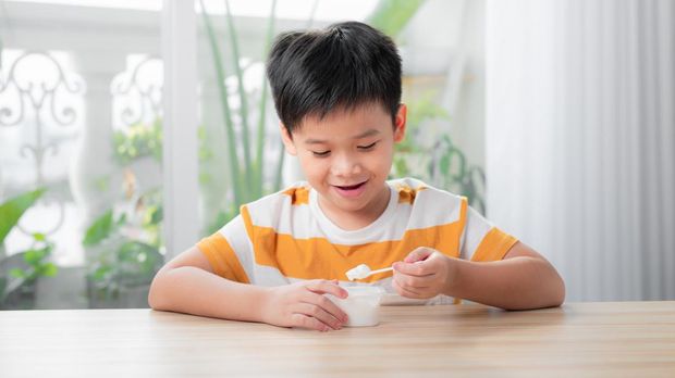 Ilustrasi anak makan es krim atau yoghurt