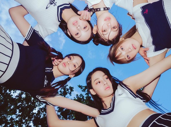NewJeans group photo in their signature natural style
