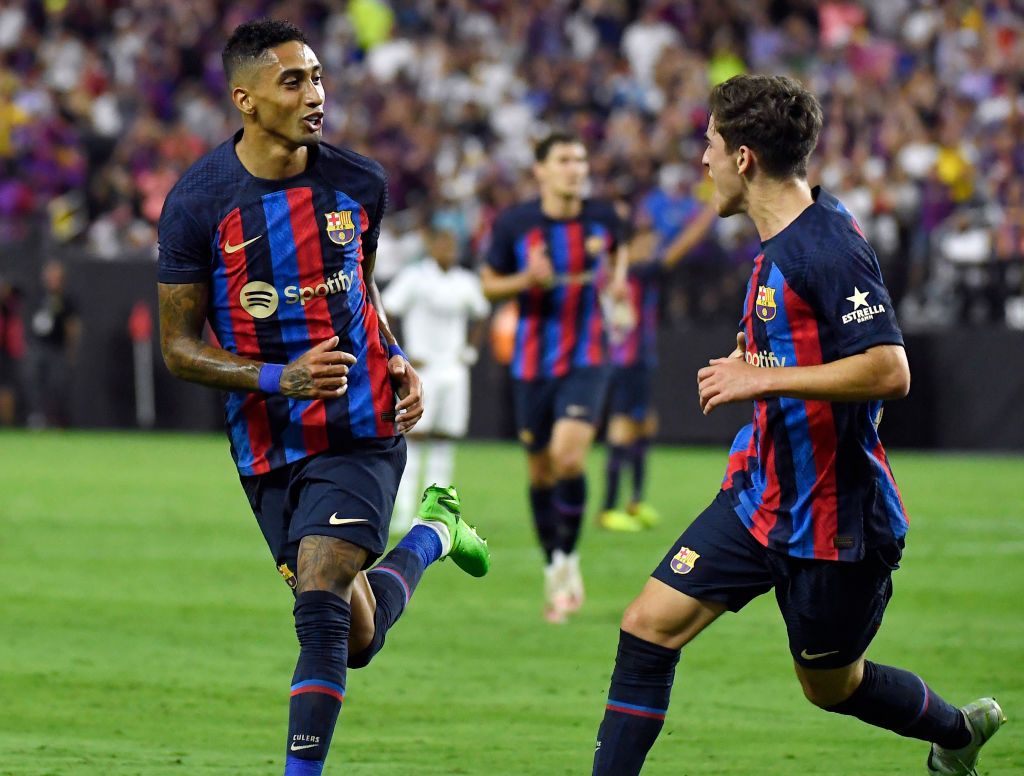 LAS VEGAS, NV - JULY 23:  Raphinha #22 of Barcelona celebrates with Pablo Paez Gavira #30 after scoring his first goal during the first half against Real Madrid during the preseason friendly match at Allegiant Stadium on July 23, 2022 in Las Vegas, Nevada. (Photo by Kevork Djansezian/Getty Images)