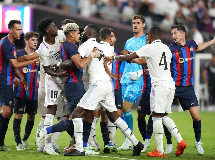Real Madrid's Vinicius Paixao gets tackled during the first half of a friendly soccer match against Barcelona, Saturday, July 23, 2022, in Las Vegas. (AP Photo/John Locher)