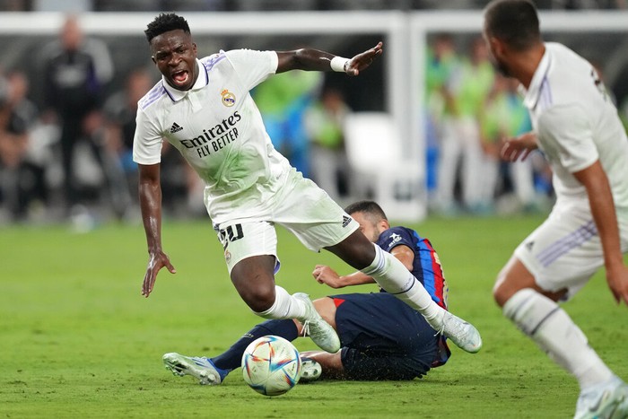 Real Madrids Vinicius Paixao gets tackled during the first half of a friendly soccer match against Barcelona, Saturday, July 23, 2022, in Las Vegas. (AP Photo/John Locher)