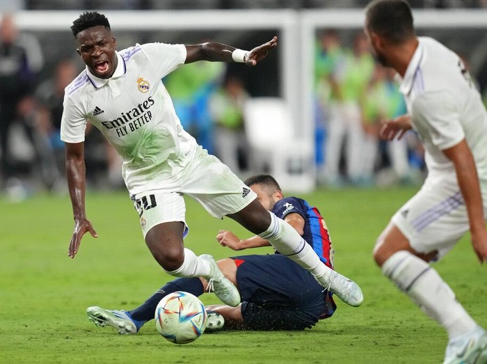 Real Madrid's Vinicius Paixao gets tackled during the first half of a friendly soccer match against Barcelona, Saturday, July 23, 2022, in Las Vegas. (AP Photo/John Locher)