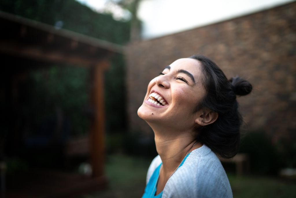 Happy woman inhaling at home