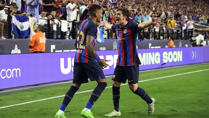 LAS VEGAS, NV - JULY 23:  Raphael “Raphinha” Dias Belloli #22 of Barcelona celebrates after his goal with Pablo Paez Gavira #30 during the first half against Real Madrid during the preseason friendly match at Allegiant Stadium on July 23, 2022 in Las Vegas, Nevada. (Photo by Kevork Djansezian/Getty Images)