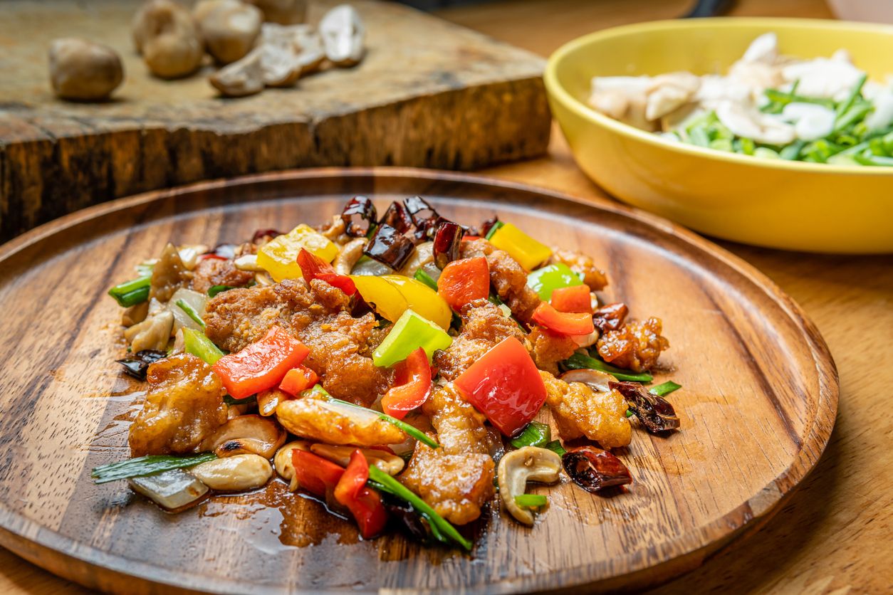 Stir fried Chicken with cashew nuts on wooden plate