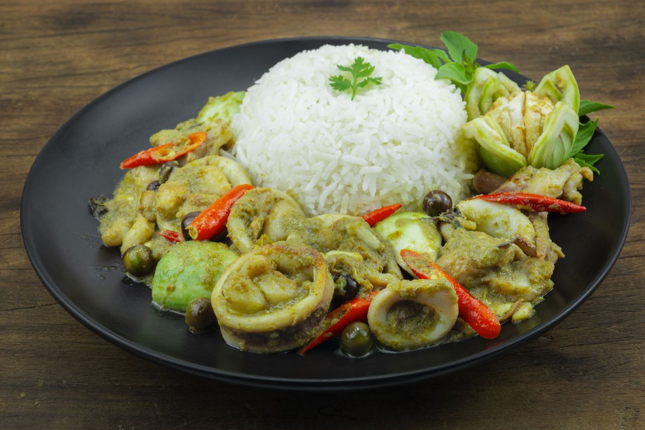 Squids with Green Curry Served Rice recipe Thaifood fusion Style decoration carved eggplant sideview