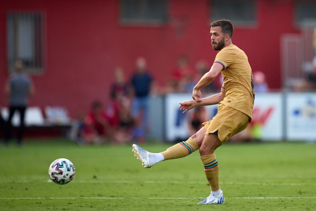 OLOT, SPAIN - JULY 13: Miralem Pjanic of FC Barcelona passes the ball during the pre-season friendly match between UE Olot and FC Barcelona at Nou Estadi Municipal on July 13, 2022 in Olot, Spain. (Photo by Alex Caparros/Getty Images)