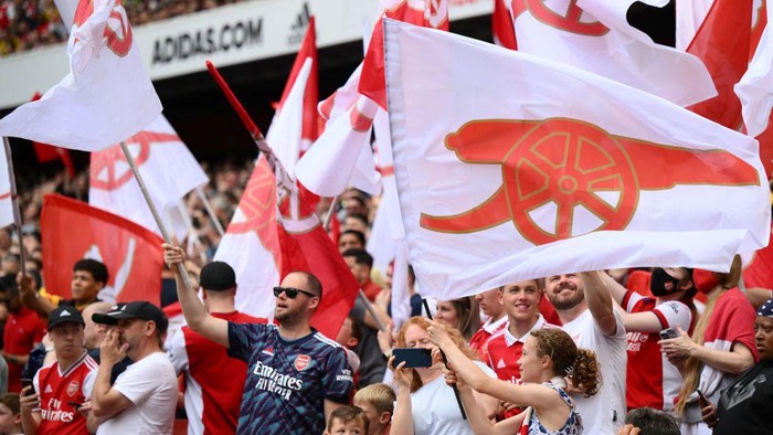 Arsenal fans cheer before the start of the English Premier League football match between Arsenal and Everton at the Emirates Stadium in London on May 22, 2022. - - RESTRICTED TO EDITORIAL USE. No use with unauthorized audio, video, data, fixture lists, club/league logos or 'live' services. Online in-match use limited to 120 images. An additional 40 images may be used in extra time. No video emulation. Social media in-match use limited to 120 images. An additional 40 images may be used in extra time. No use in betting publications, games or single club/league/player publications. (Photo by Daniel LEAL / AFP) / RESTRICTED TO EDITORIAL USE. No use with unauthorized audio, video, data, fixture lists, club/league logos or 'live' services. Online in-match use limited to 120 images. An additional 40 images may be used in extra time. No video emulation. Social media in-match use limited to 120 images. An additional 40 images may be used in extra time. No use in betting publications, games or single club/league/player publications. / RESTRICTED TO EDITORIAL USE. No use with unauthorized audio, video, data, fixture lists, club/league logos or 'live' services. Online in-match use limited to 120 images. An additional 40 images may be used in extra time. No video emulation. Social media in-match use limited to 120 images. An additional 40 images may be used in extra time. No use in betting publications, games or single club/league/player publications. (Photo by DANIEL LEAL/AFP via Getty Images)