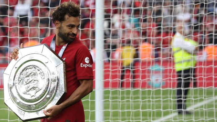 Mohamed Salah Liverpool's Egyptian midfielder Mohamed Salah celebrates with the trophy after winning the English FA Community Shield football match between Liverpool and Manchester City at the King Power Stadium in Leicester on July 30, 2022. - Liverpool won the Community Shield for the first time since 2006 as Darwin Nunez came off the bench to score his first competitive goal for the Reds in a 3-1 win over Manchester City. Trent Alexander-Arnold and Mohamed Salah were also on target for Jurgen Klopp's men as Erling Haaland's much-anticipated debut for City ended in defeat. (Photo by Nigel Roddis / AFP) (Photo by NIGEL RODDIS/AFP via Getty Images)