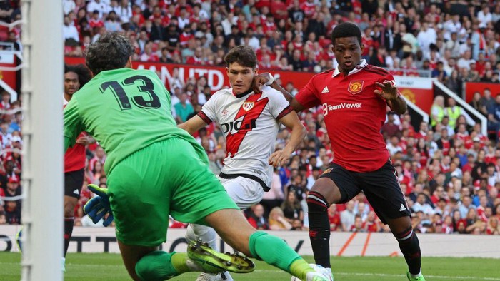 Manchester United vs Rayo Vallecano Manchester United's Ivorian midfielder Amad Diallo (R) prepares to shoot, as he scores the opening goal of the pre-season club friendly football match between Manchester United and Rayo Vallecano at Old Trafford in Manchester, north west England, on July 31, 2022. (Photo by Nigel Roddis / AFP) (Photo by NIGEL RODDIS/AFP via Getty Images)